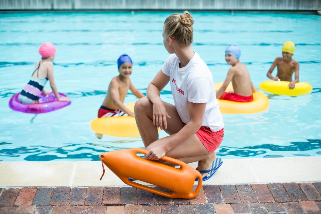 lifeguard overseeing children swimming
