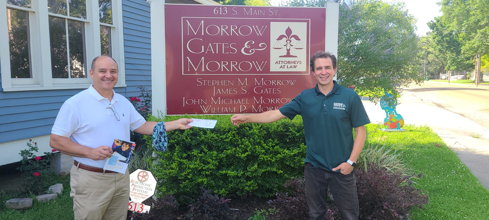 Jim Gates presenting sponsorship check to Loren Carriere with Hope for Opelousas
